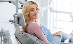 Woman smiling while sitting in treatment chair