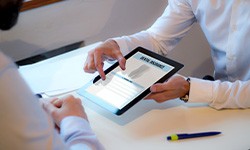 Patient reviewing dental insurance form on tablet