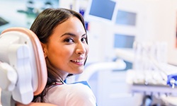 Woman sitting in a dental chair and smiling